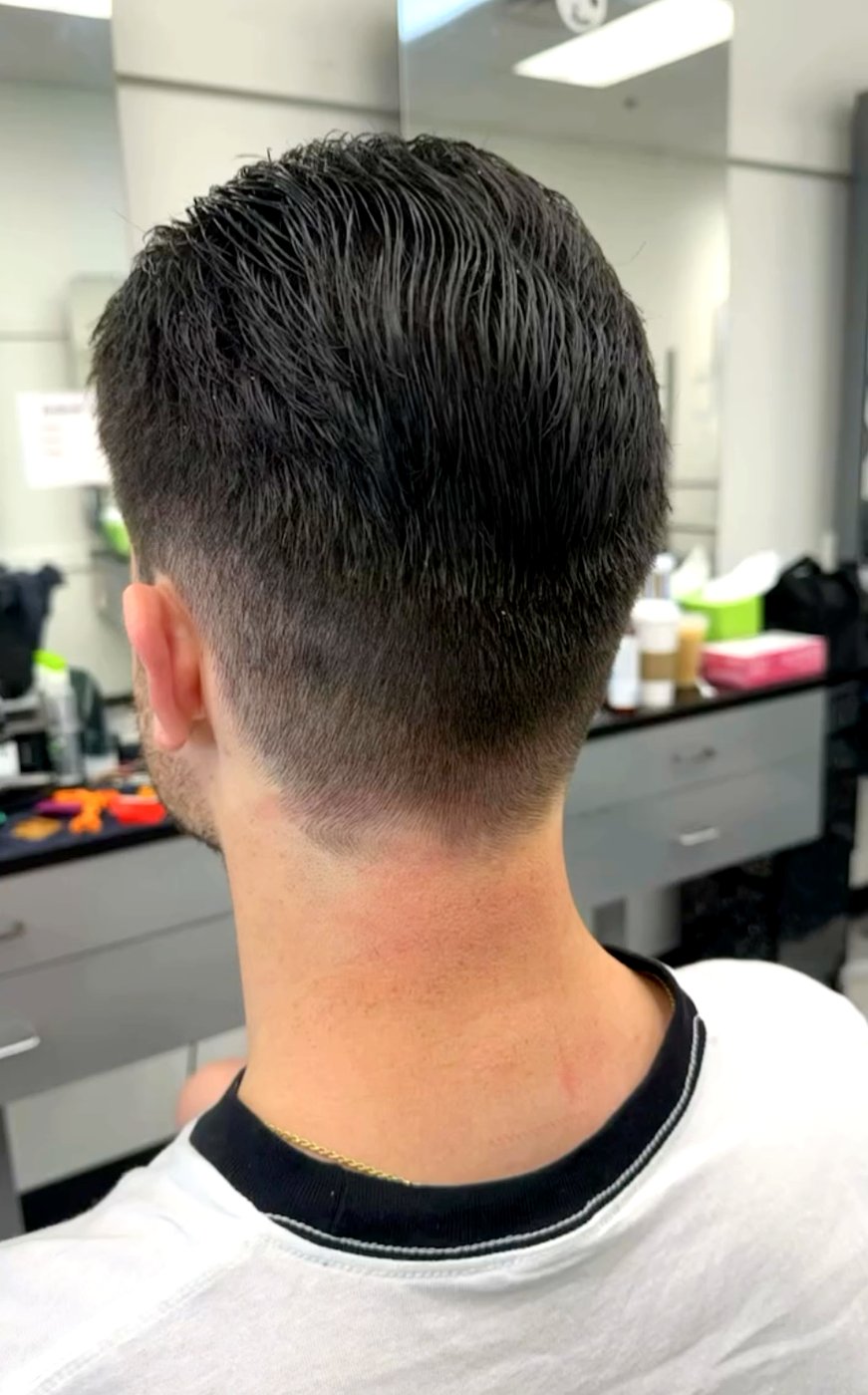 A clean men’s taper-fade haircut, back view.