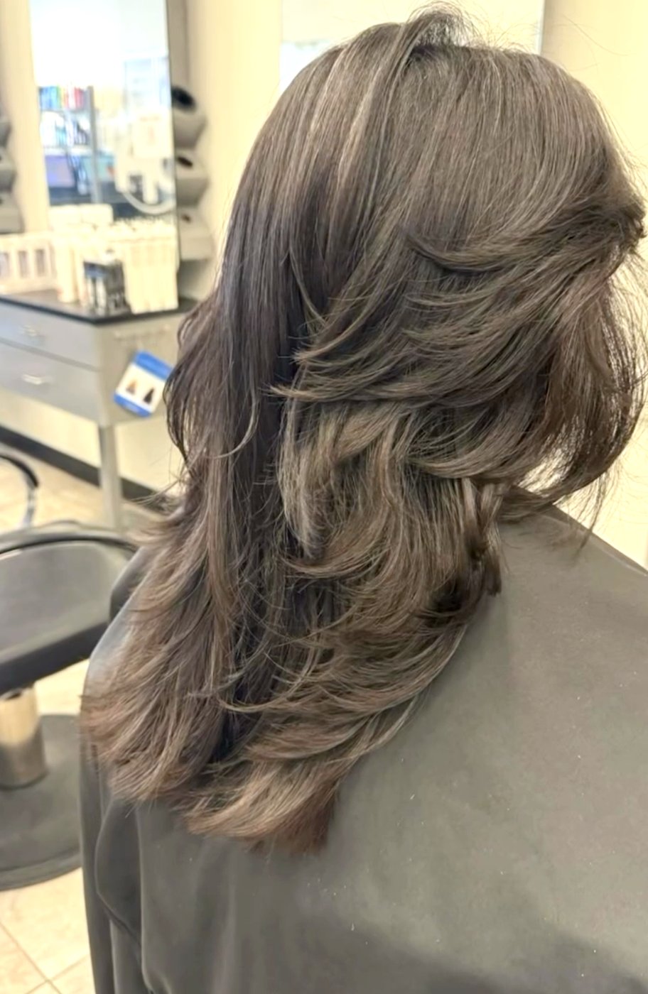 A layered, face-framing cut with soft movement.